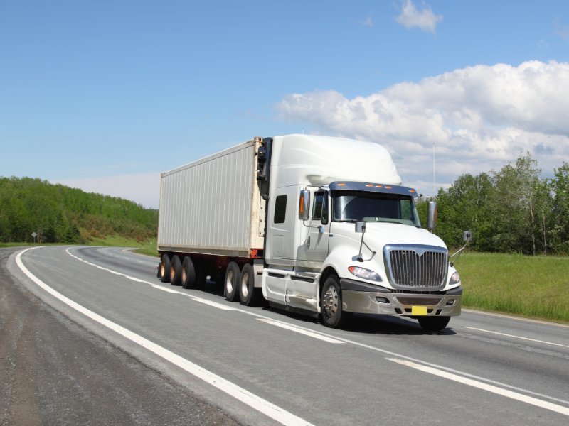 Large semi-truck driving down freeway